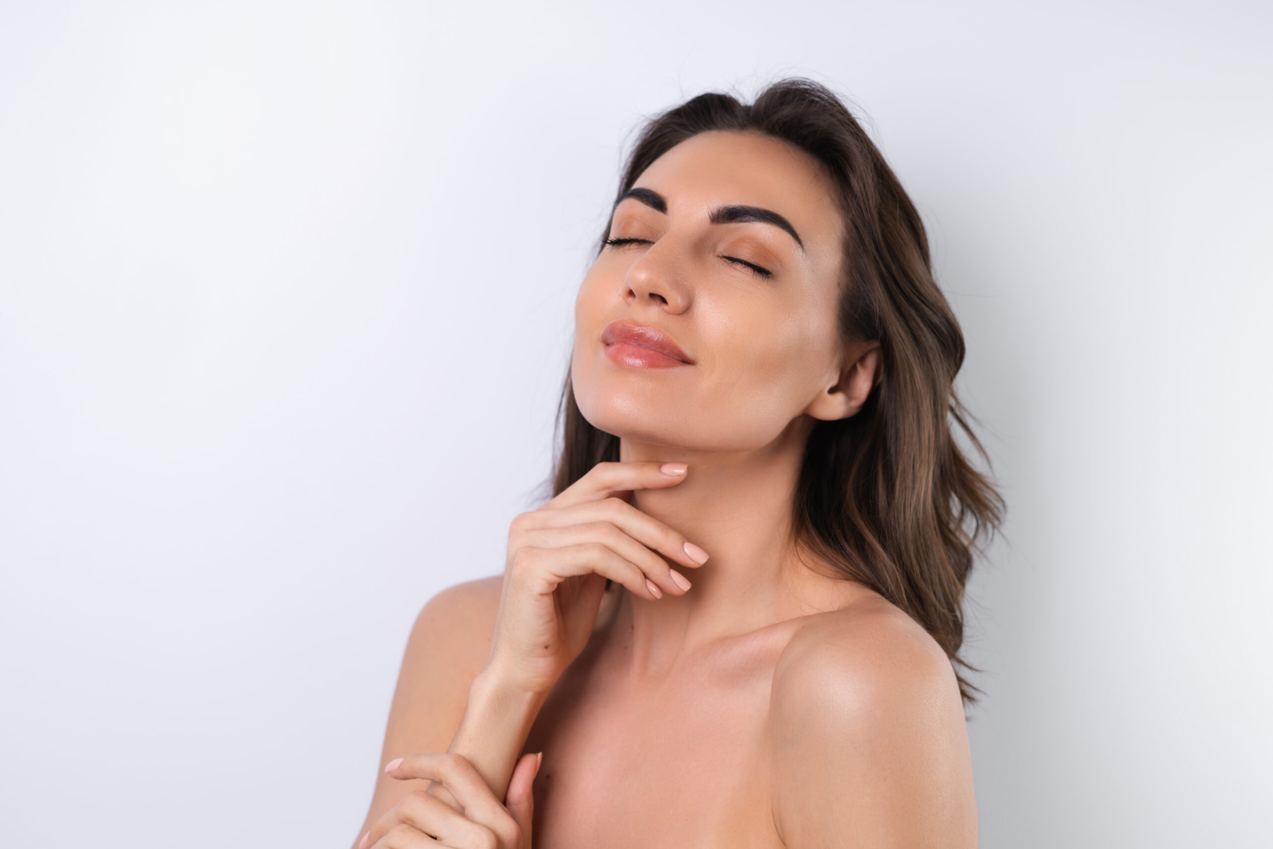 Close-up beauty portrait of a topless woman with perfect skin and natural make-up